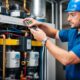 A technician demonstrating refrigeration system components and maintenance procedures
