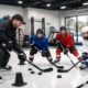 Youth hockey players practicing skills on an indoor rink