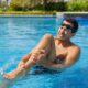 Swimmer holding a painful leg during a pool cramp